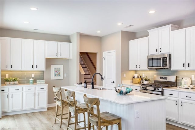 2000 Venture Way Unit B, Suffolk, VA 23434 - kitchen with stainless steel appliances, a sink, a center island with sink, backsplash, and light countertops