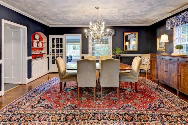 21 Westover Rd, Newport News, VA 23601 - dining room with healthy amount of natural light, a chandelier, wood finished floors, and crown molding