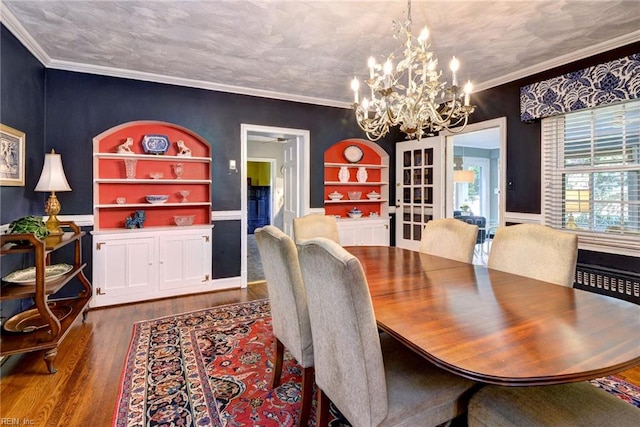 21 Westover Rd, Newport News, VA 23601 - dining area with a chandelier, wood finished floors, built in features, crown molding, and wainscoting