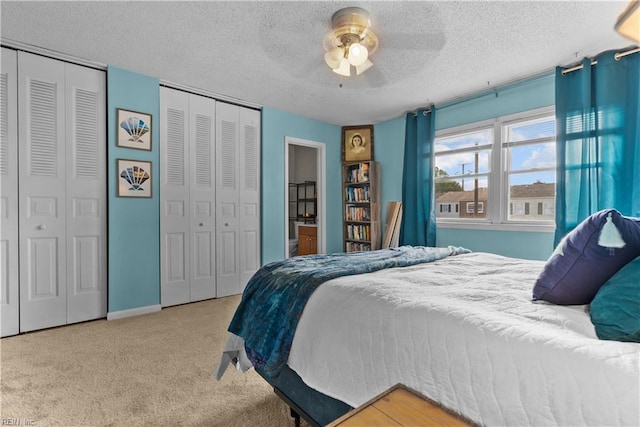 423 Burr Oak Ct, Virginia Beach, VA 23454 - bedroom with two closets, carpet, a textured ceiling, ceiling fan, and baseboards