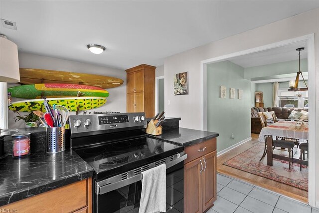 423 Burr Oak Ct, Virginia Beach, VA 23454 - kitchen with stainless steel electric range oven, dark countertops, light tile patterned flooring, and brown cabinetry