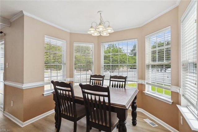 968 Speight Lyons Loop, Chesapeake, VA 23322 - dining space with baseboards, wood finished floors, a chandelier, healthy amount of natural light, and ornamental molding