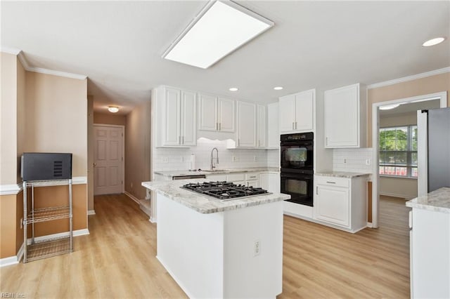 968 Speight Lyons Loop, Chesapeake, VA 23322 - kitchen with appliances with stainless steel finishes, a sink, light wood-type flooring, white cabinetry, and ornamental molding