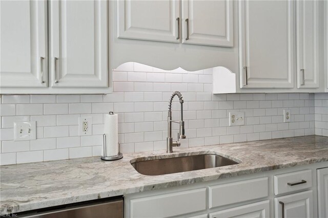 968 Speight Lyons Loop, Chesapeake, VA 23322 - kitchen with a sink, white cabinets, stainless steel dishwasher, light stone counters, and decorative backsplash
