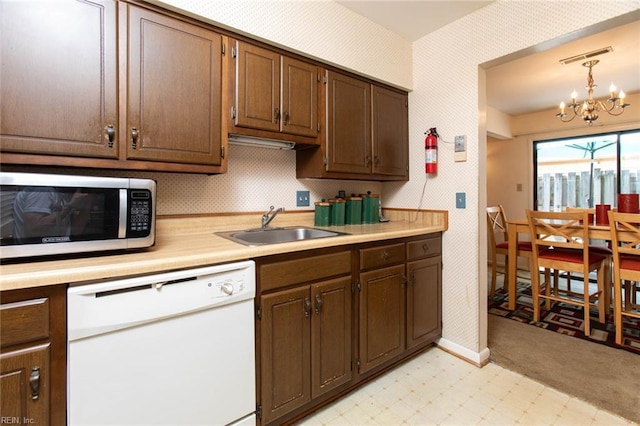 1371 Granada Ct, Newport News, VA 23608 - kitchen featuring white dishwasher, stainless steel microwave, a sink, wallpapered walls, and light countertops