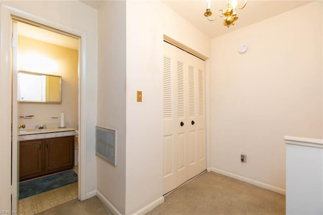 1371 Granada Ct, Newport News, VA 23608 - hall with a chandelier, baseboards, light carpet, and a sink
