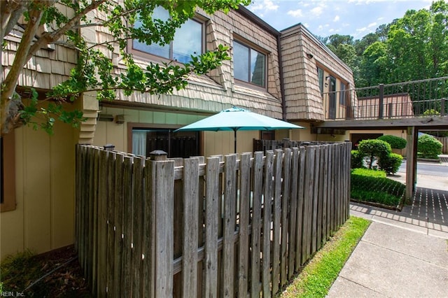 1371 Granada Ct, Newport News, VA 23608 - view of home's exterior with a balcony, mansard roof, and fence