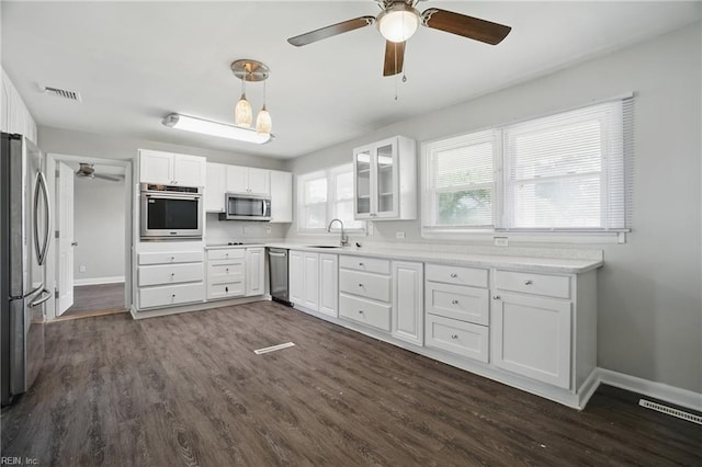 kitchen featuring appliances with stainless steel finishes, a ceiling fan, baseboards, and white cabinetry