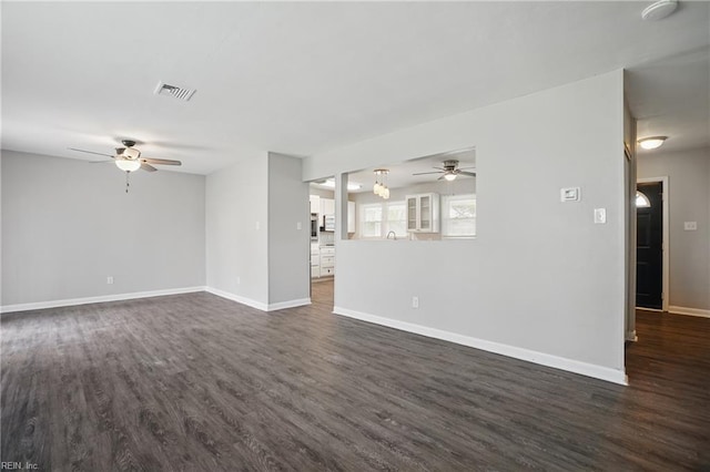 unfurnished living room with ceiling fan, dark wood-style floors, and baseboards