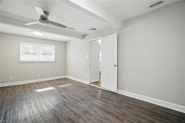 spare room with dark wood-style floors, baseboards, a ceiling fan, and beam ceiling