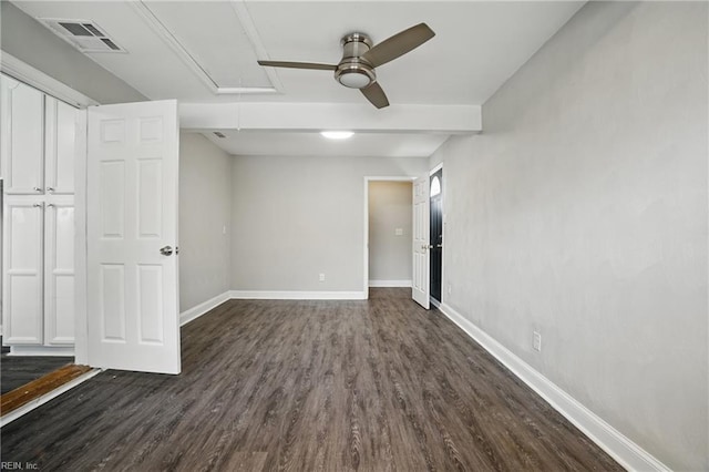unfurnished bedroom with attic access, dark wood finished floors, baseboards, and a ceiling fan