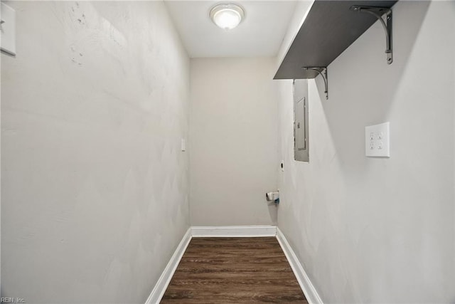 washroom featuring wood finished floors, electric panel, and baseboards
