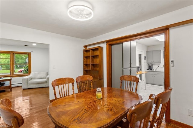 13 Omera Pl, Hampton, VA 23666 - dining area with light wood-style flooring, a baseboard heating unit, and baseboards