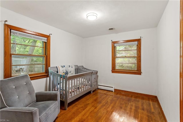 13 Omera Pl, Hampton, VA 23666 - bedroom featuring baseboard heating, multiple windows, wood finished floors, and baseboards