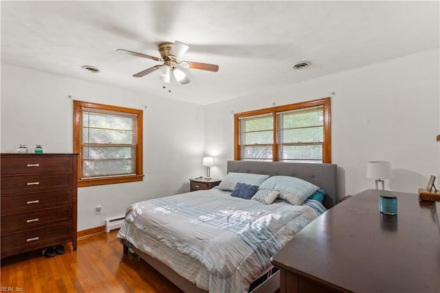 13 Omera Pl, Hampton, VA 23666 - bedroom featuring wood finished floors, a baseboard radiator, baseboards, and a ceiling fan
