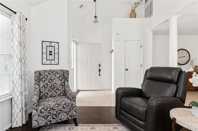 3009 Hogan Way, Suffolk, VA 23435 - living area with ornate columns, plenty of natural light, wood finished floors, a high ceiling, and baseboards