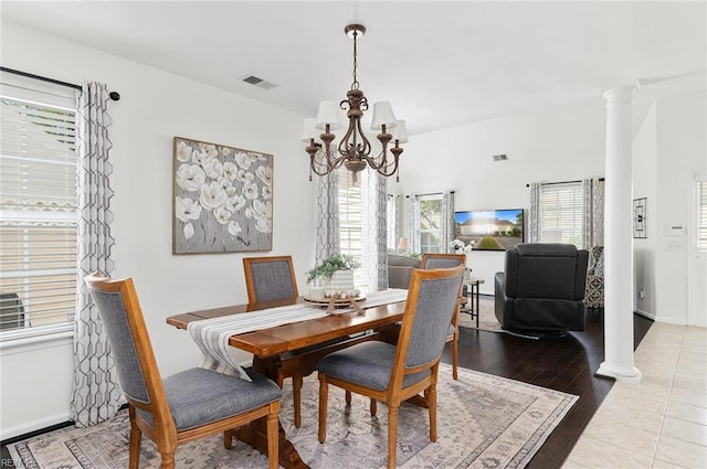 3009 Hogan Way, Suffolk, VA 23435 - dining room featuring a chandelier, wood finished floors, and ornate columns