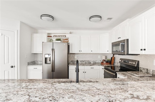 3009 Hogan Way, Suffolk, VA 23435 - kitchen featuring appliances with stainless steel finishes, a sink, open shelves, light stone countertops, and white cabinetry