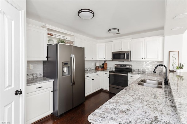 3009 Hogan Way, Suffolk, VA 23435 - kitchen featuring appliances with stainless steel finishes, a sink, light stone countertops, and white cabinetry