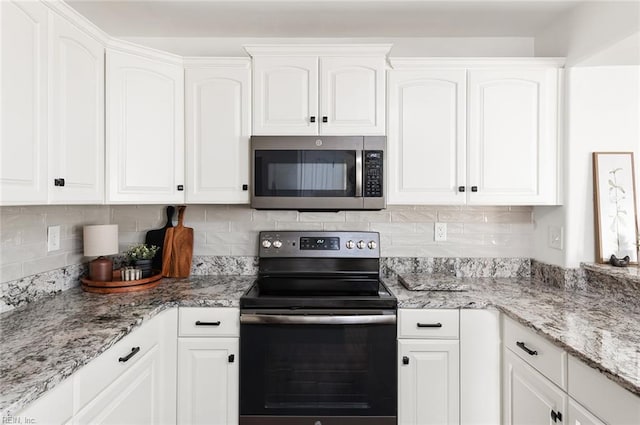 3009 Hogan Way, Suffolk, VA 23435 - kitchen with stainless steel appliances, white cabinets, and decorative backsplash