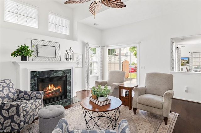 3009 Hogan Way, Suffolk, VA 23435 - living area featuring wood finished floors, a high end fireplace, ceiling fan, and a towering ceiling