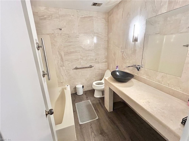 4402 Point W Dr, Portsmouth, VA 23703 - full bathroom with wood finished floors, toilet, vanity, and tile walls