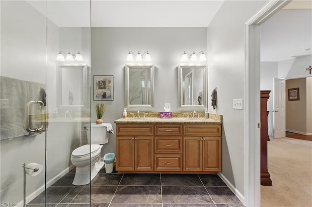 bathroom with double vanity, baseboards, and toilet