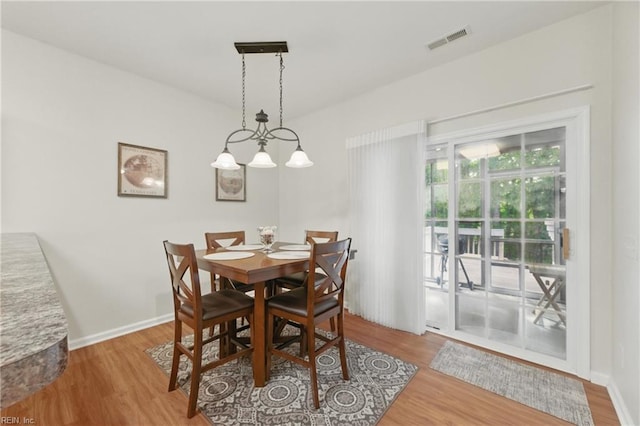 dining area featuring wood finished floors and baseboards