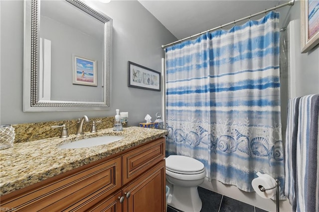 bathroom featuring toilet, tile patterned floors, and vanity