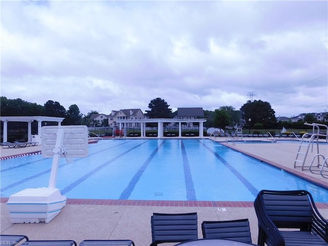 community pool featuring a pergola and a patio