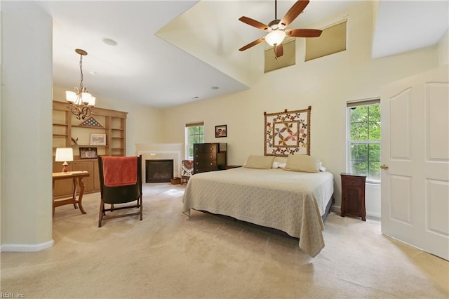 bedroom featuring multiple windows, light carpet, a chandelier, and a towering ceiling