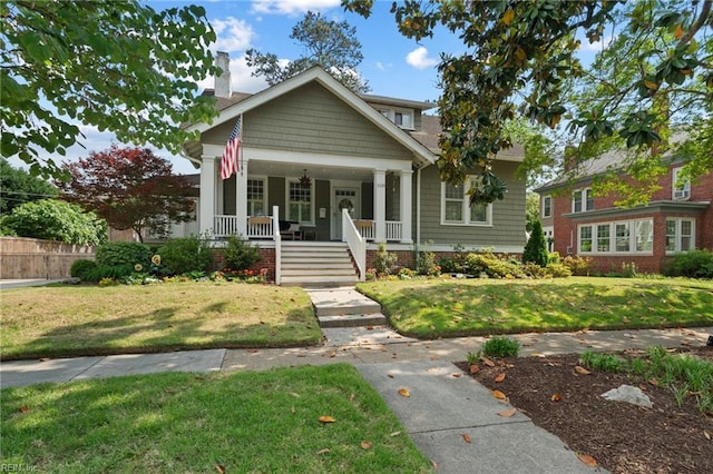 view of front facade with a porch and a chimney