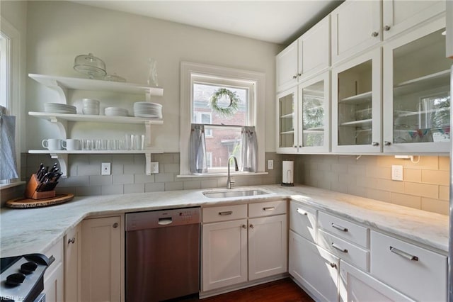 kitchen featuring stainless steel dishwasher, a sink, decorative backsplash, light stone counters, and white cabinets
