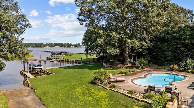 outdoor pool featuring a water view, a boat dock, boat lift, and a lawn