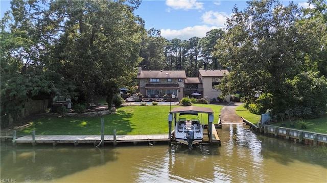 dock area with a water view and a yard