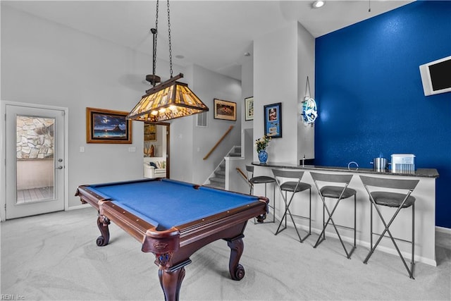 game room featuring carpet floors, billiards table, baseboards, a towering ceiling, and bar with sink