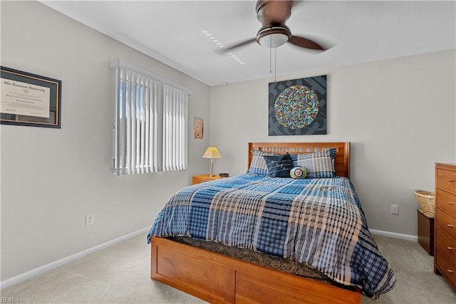 bedroom with carpet flooring, baseboards, and a ceiling fan