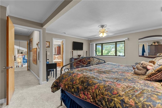 carpeted bedroom with crown molding, baseboards, ceiling fan, ensuite bath, and a textured ceiling