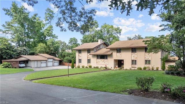 view of front of house with a front yard, stone siding, and stucco siding
