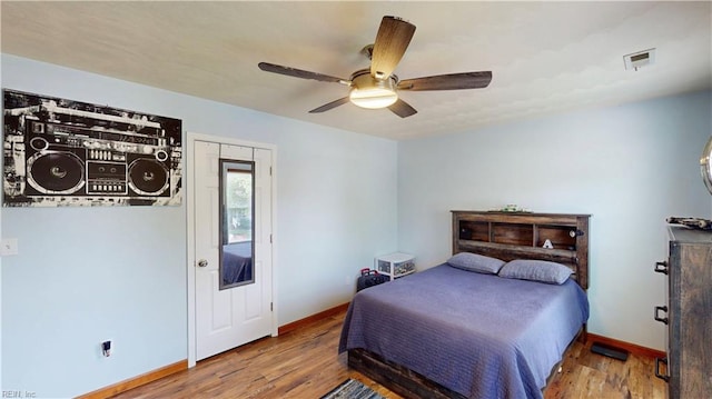 bedroom featuring wood finished floors, baseboards, and ceiling fan