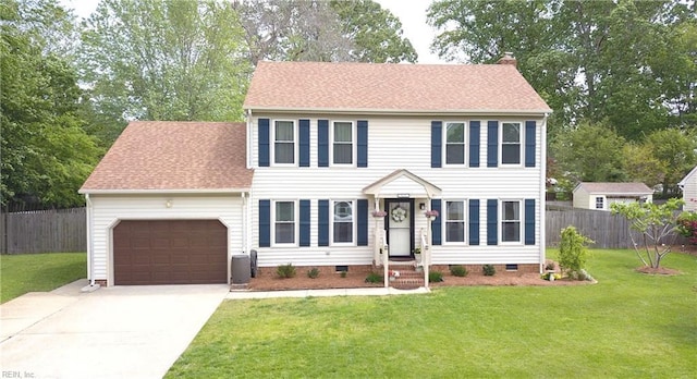 colonial inspired home featuring an attached garage, concrete driveway, crawl space, a chimney, and a shingled roof