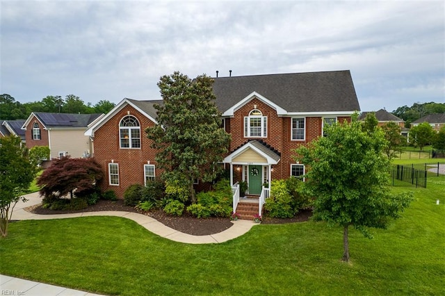 view of front of home with brick siding and roof with shingles