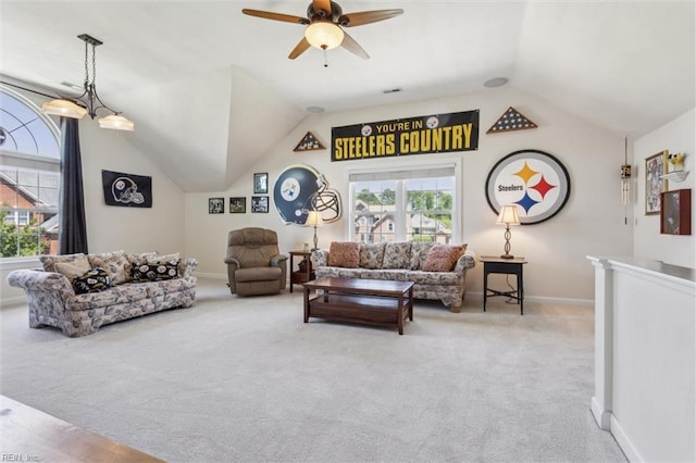 living area featuring carpet flooring, lofted ceiling, baseboards, and a ceiling fan