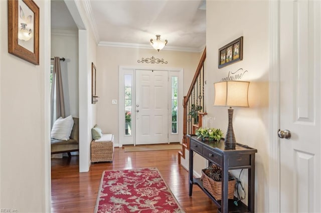 foyer featuring wood finished floors and crown molding