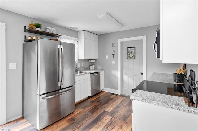 8209 Harlan Dr, Suffolk, VA 23436 - kitchen with appliances with stainless steel finishes, white cabinets, dark wood-style floors, a sink, and a textured ceiling