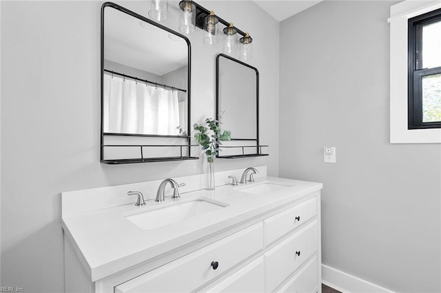 8209 Harlan Dr, Suffolk, VA 23436 - bathroom featuring double vanity and baseboards