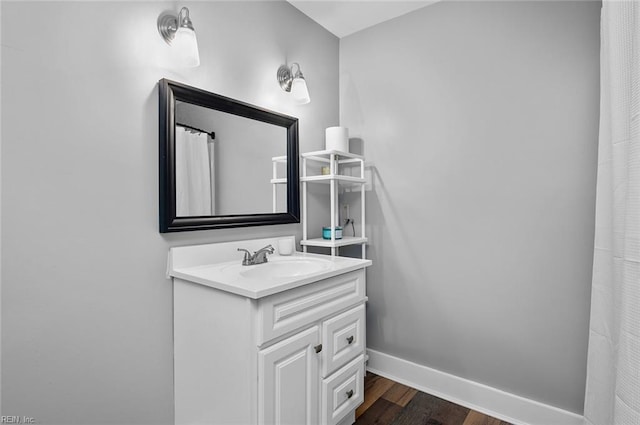 8209 Harlan Dr, Suffolk, VA 23436 - full bathroom featuring wood finished floors, baseboards, and vanity