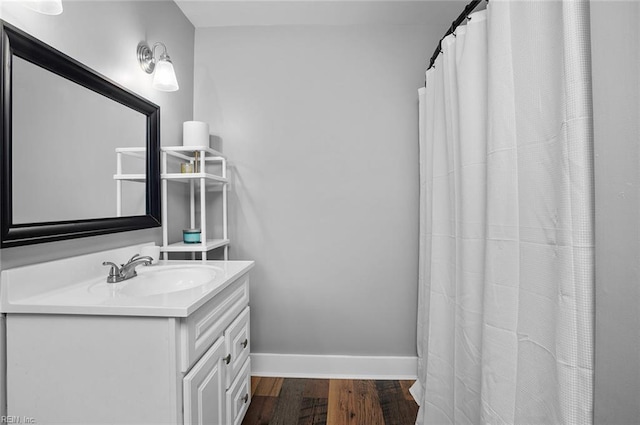 8209 Harlan Dr, Suffolk, VA 23436 - bathroom featuring wood finished floors, vanity, and baseboards