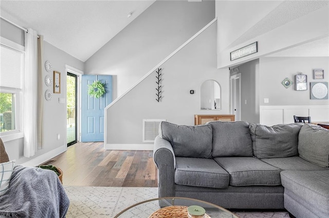 8209 Harlan Dr, Suffolk, VA 23436 - living room featuring wood finished floors, high vaulted ceiling, and baseboards