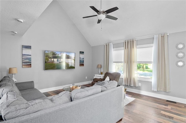 8209 Harlan Dr, Suffolk, VA 23436 - living area with baseboards, a ceiling fan, wood finished floors, and high vaulted ceiling